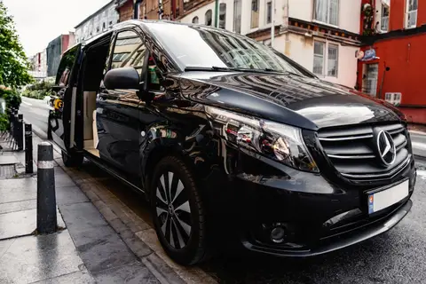 Black Mercedes-Benz V-Class minivan with its sliding door open
